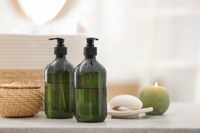 Photo of Green soap dispensers on white countertop in bathroom. Space for text