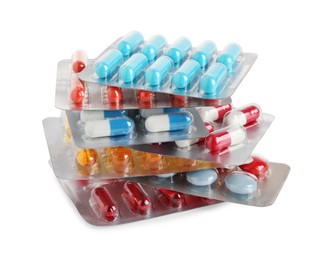 Stack of blisters with different pills on white background