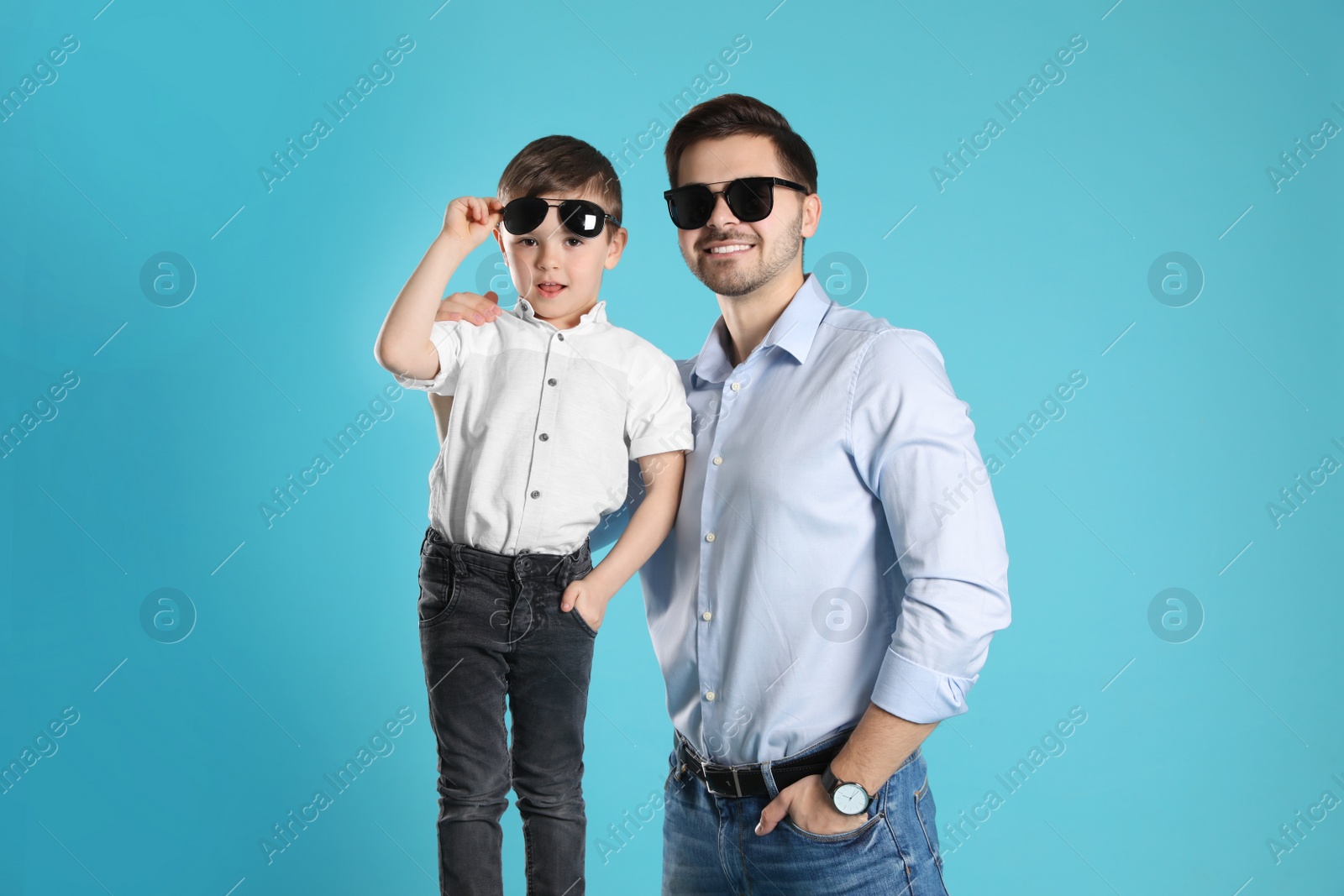 Photo of Portrait of dad and his son on color background