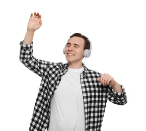 Handsome young man with headphones dancing on white background