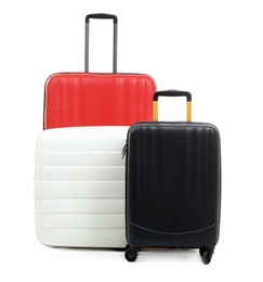 Photo of New suitcases packed for journey on white background