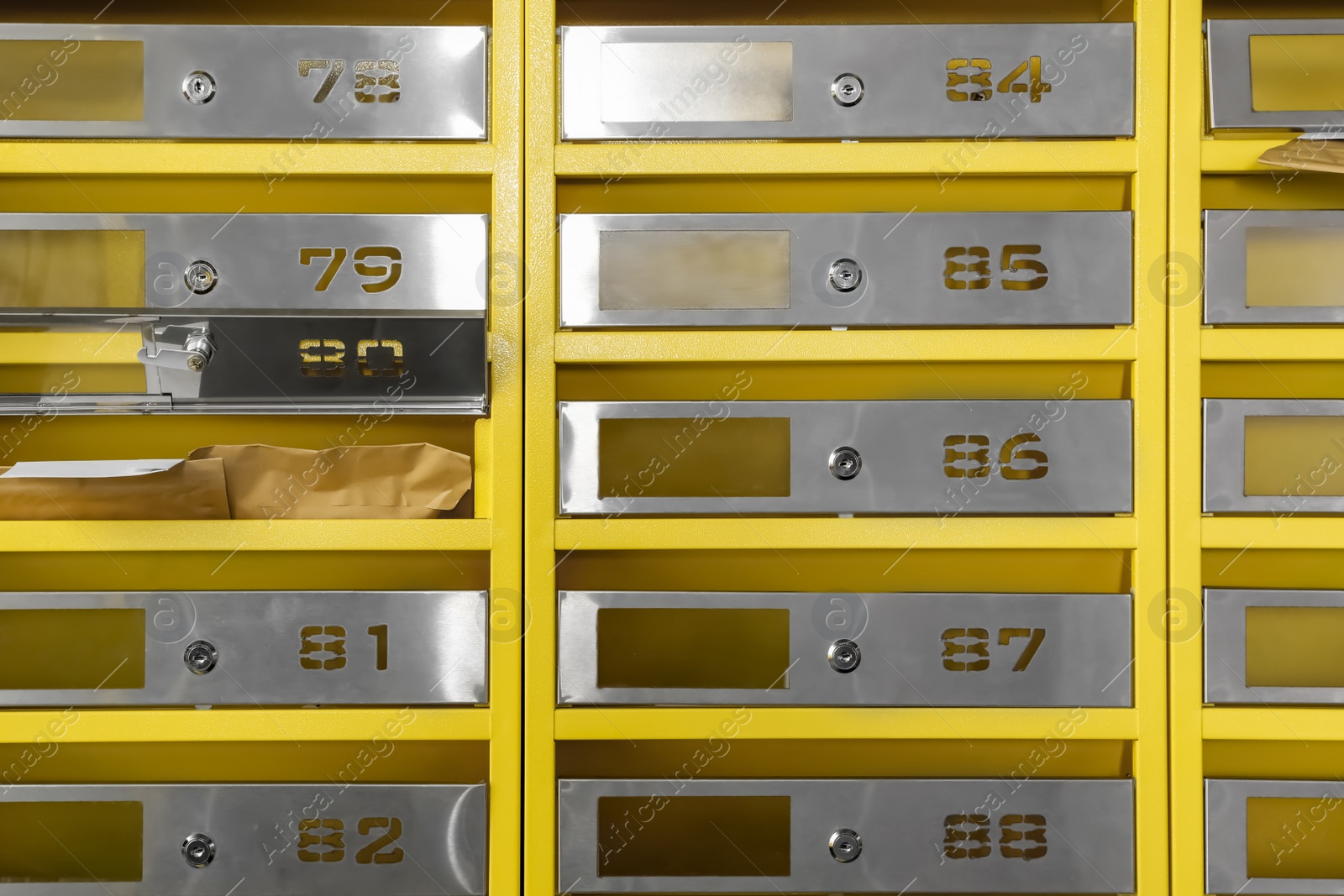 Photo of Metal mailboxes with keyholes, numbers and correspondence in post office