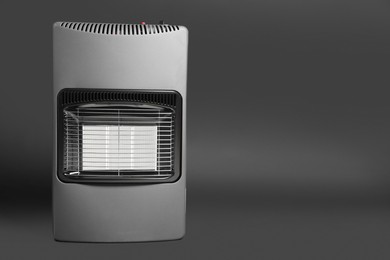 Modern gas heater on dark grey background, space for text. Military equipment