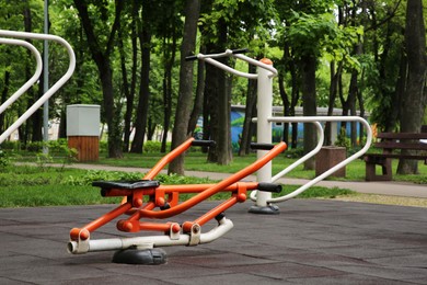 Photo of Empty outdoor gym with push up bars and rowing machine