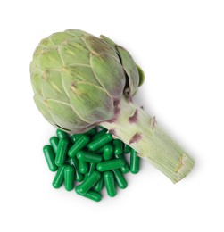 Photo of Fresh artichoke and pills isolated on white, top view