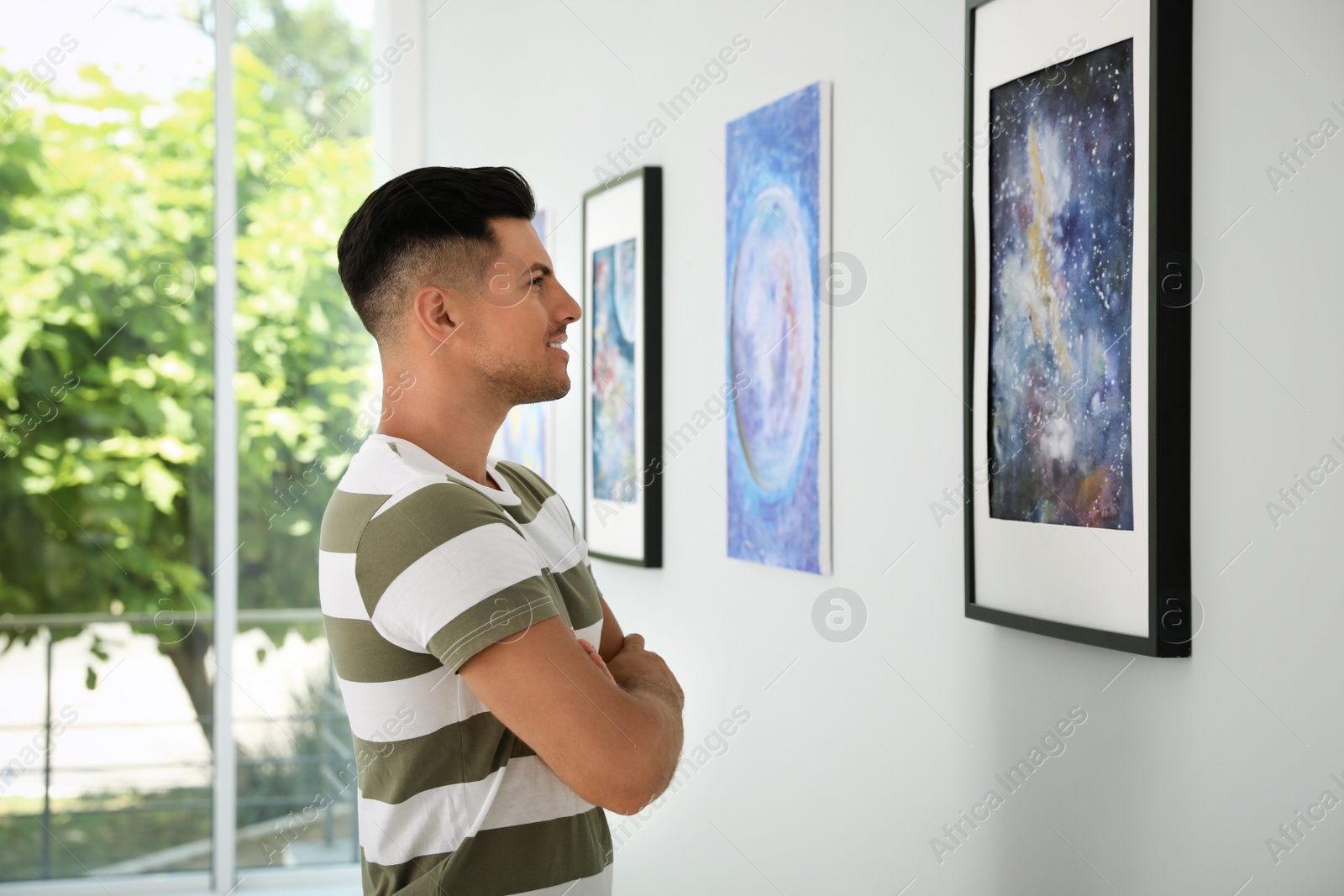 Photo of Happy man at exhibition in art gallery