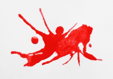 Blot of red ink on white background, top view