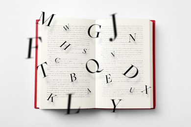 Image of Open book with letters flying out of it on white background, top view