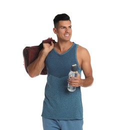 Handsome man with sports bag and bottle of water on white background