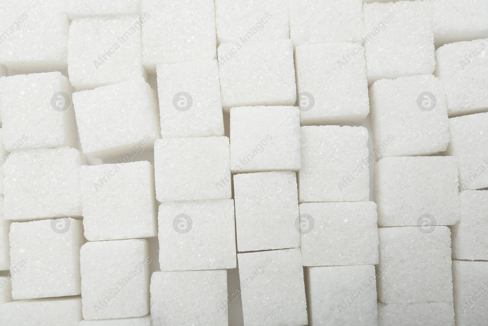 Photo of White sugar cubes as background, top view