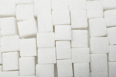 Photo of White sugar cubes as background, top view