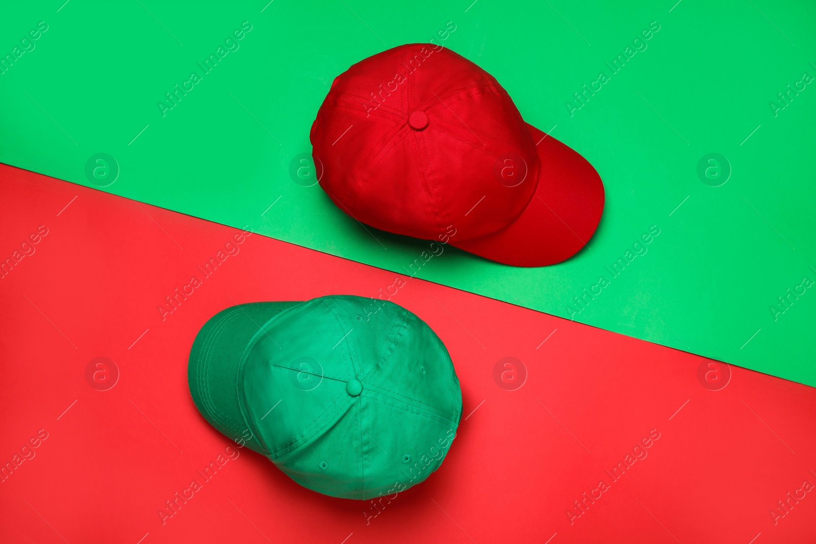 Photo of Baseball caps on color background, flat lay Mock up for design