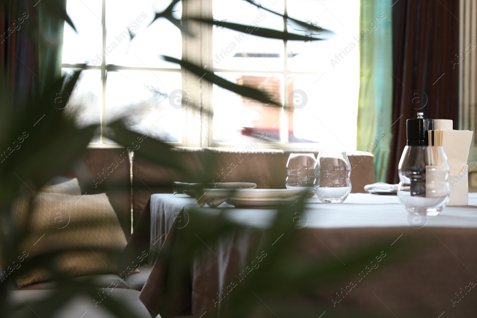Table with plates and empty glasses in restaurant Photo of Table with plates and empty glasses in restaurant