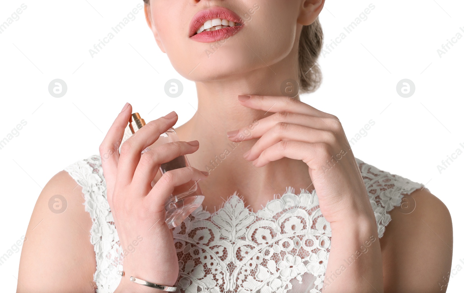 Photo of Beautiful young bride with bottle of perfume on white background, closeup