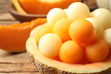 Different melon balls on wooden table, closeup