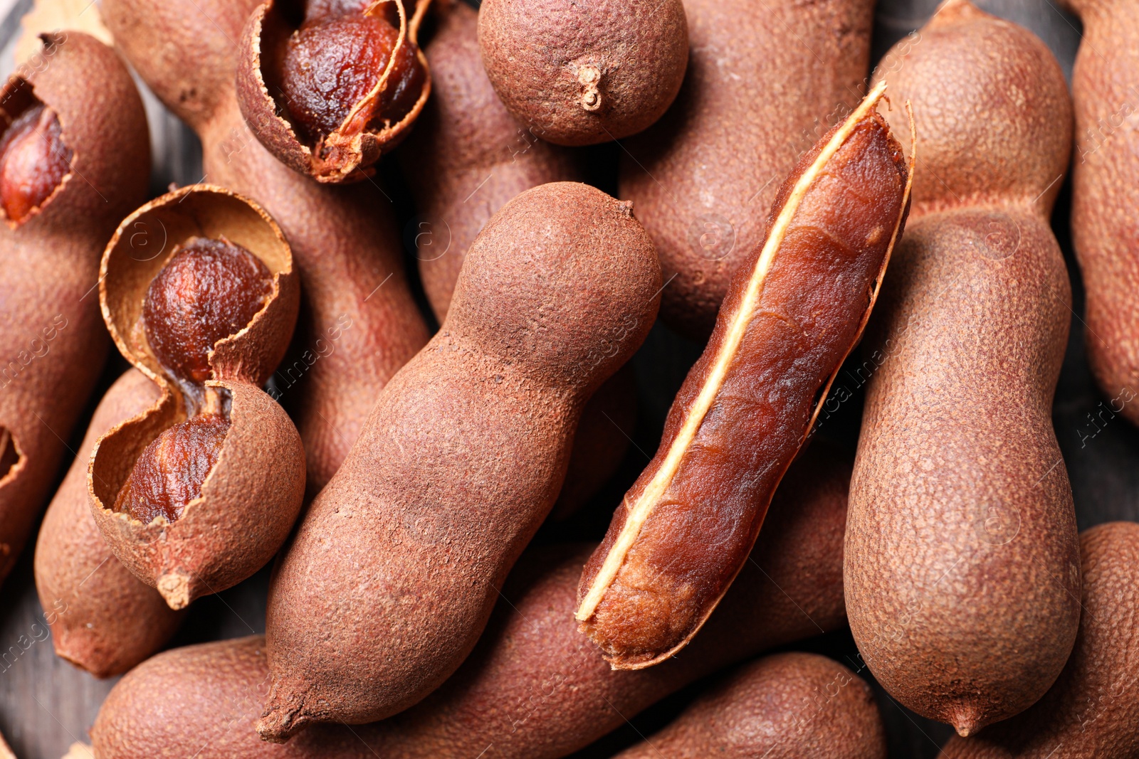 Photo of Pile of delicious ripe tamarinds, closeup view