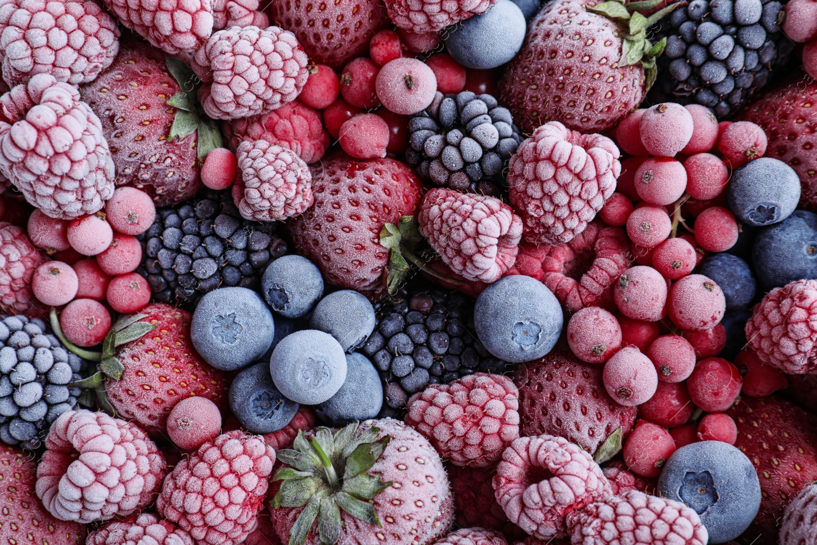 Photo of Mix of different frozen berries as background, top view