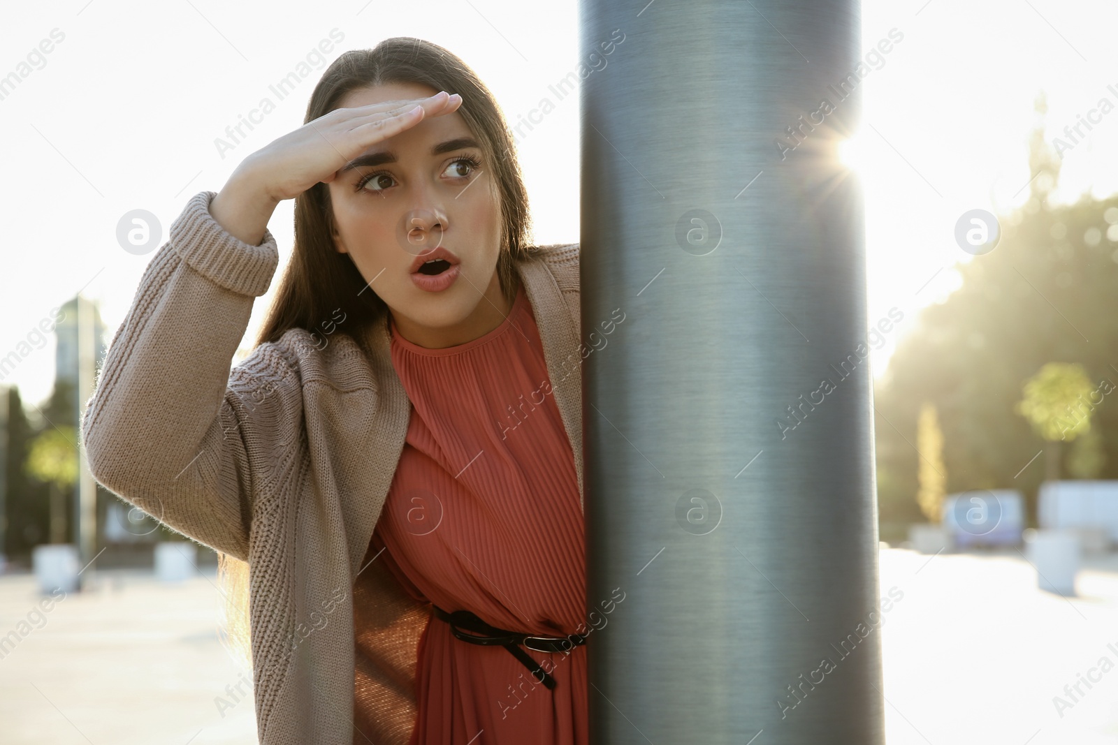 Photo of Jealous woman spying on ex boyfriend outdoors