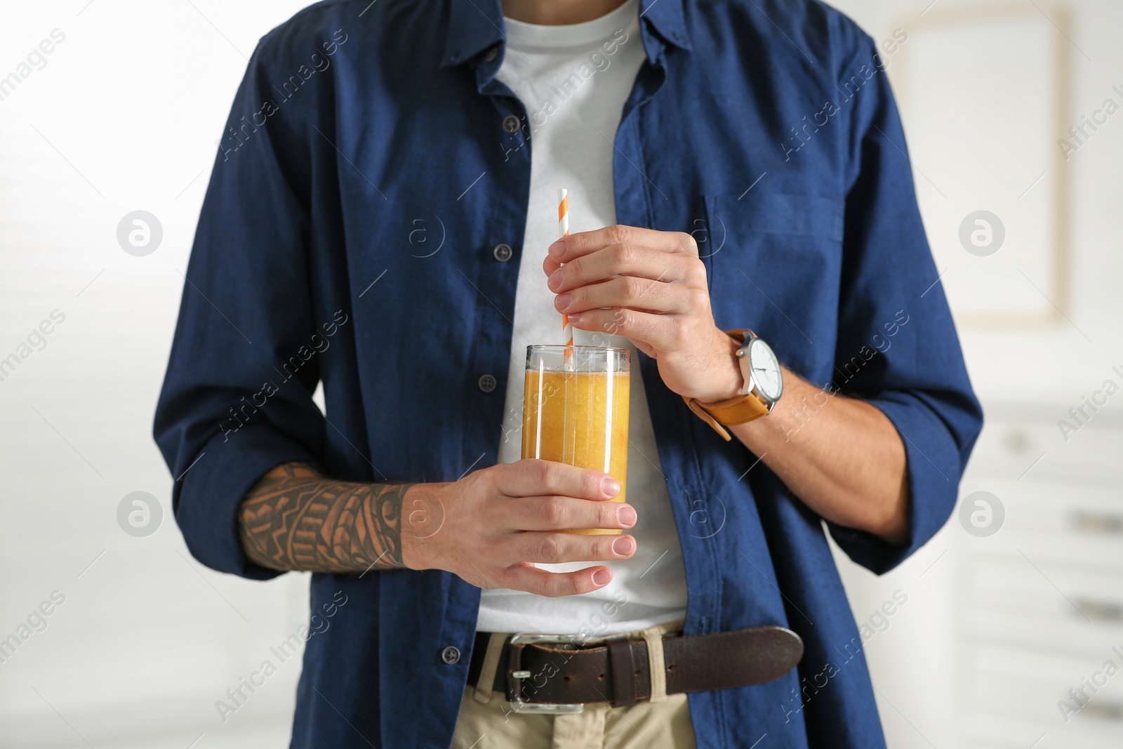 Photo of Man with delicious smoothie at home, closeup