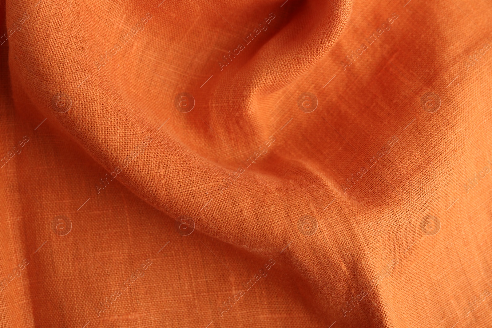 Photo of Texture of beautiful orange fabric as background, closeup