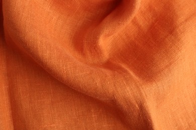 Photo of Texture of beautiful orange fabric as background, closeup