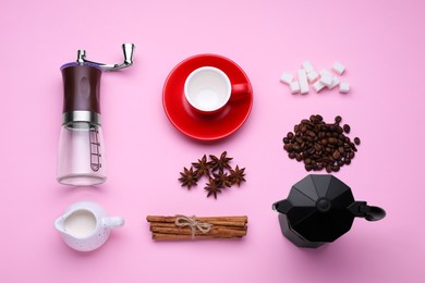 Flat lay composition with manual coffee grinder and spices on pink background