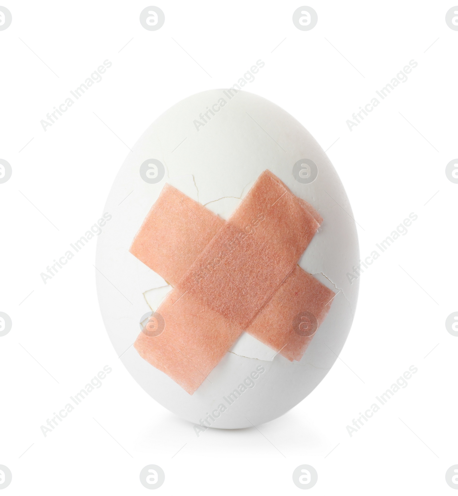 Photo of Cracked egg with sticking plasters isolated on white