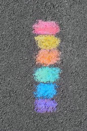 Photo of Rainbow chalk strokes on asphalt, top view