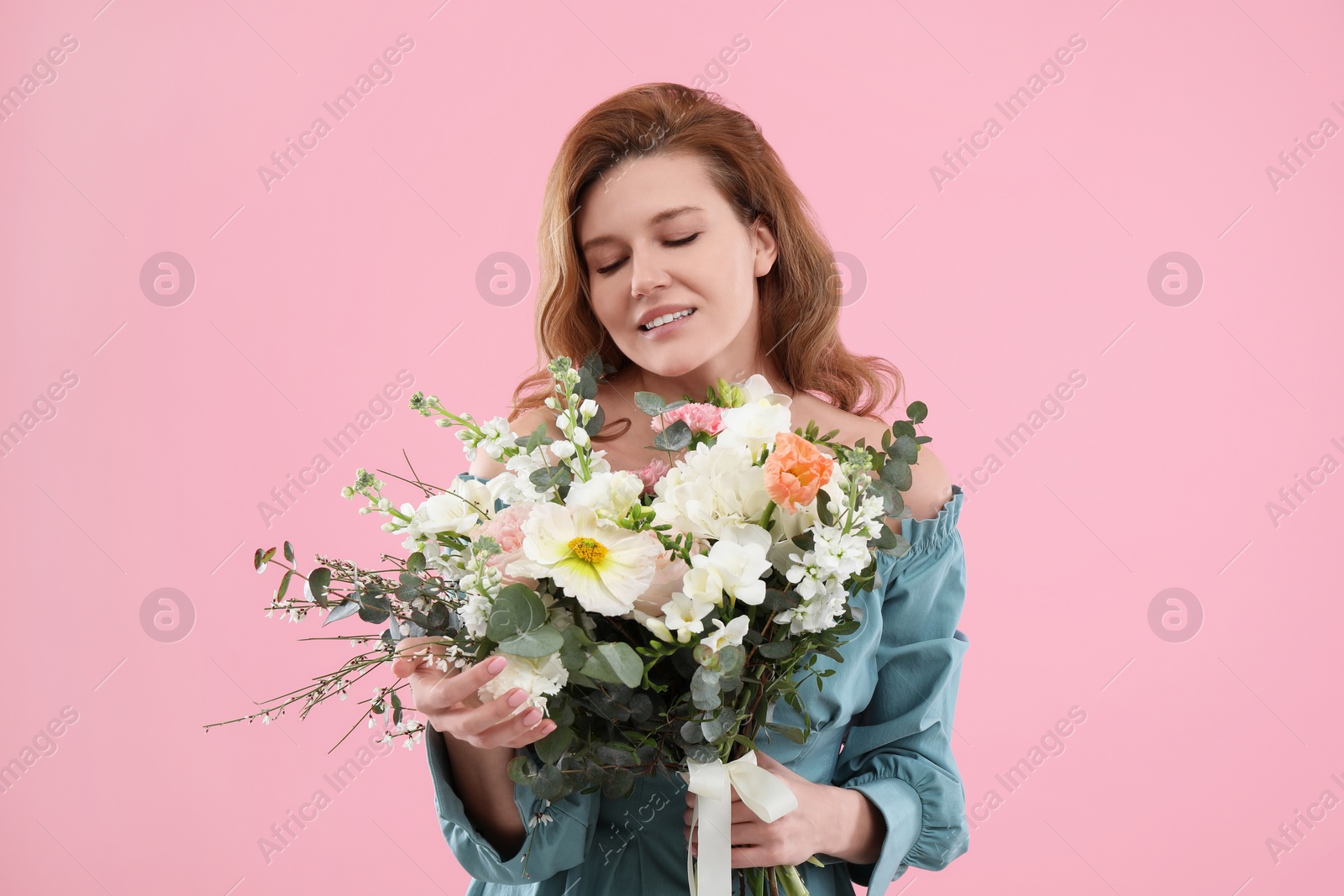 Photo of Beautiful woman with bouquet of flowers on pink background