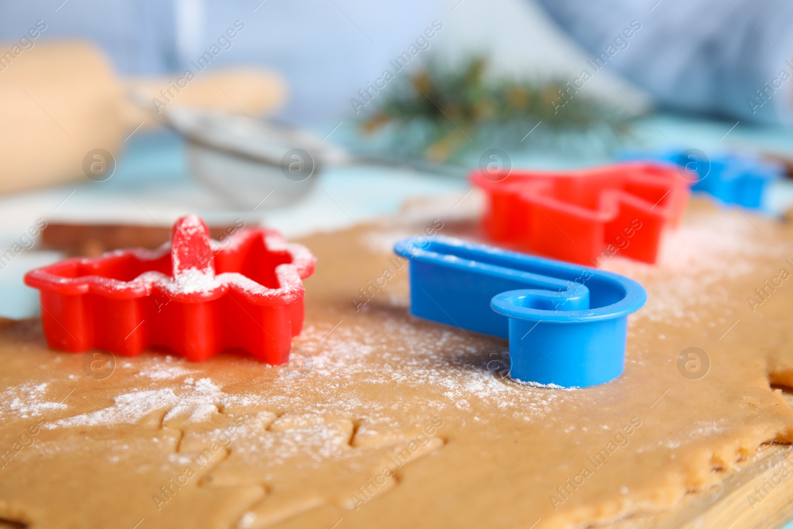 Photo of Making homemade Christmas cookies. Dough and cutters on table, closeup