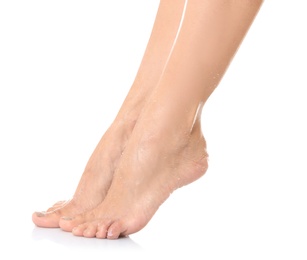 Photo of Female legs with applied natural scrub against white background