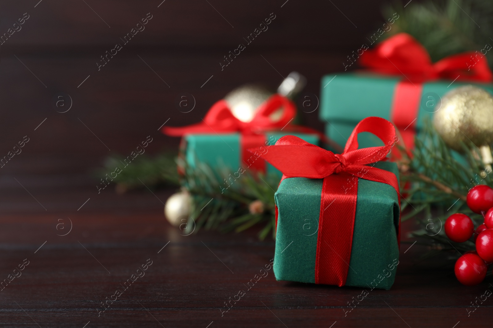 Photo of Gift boxes and Christmas decorations on wooden table, space for text