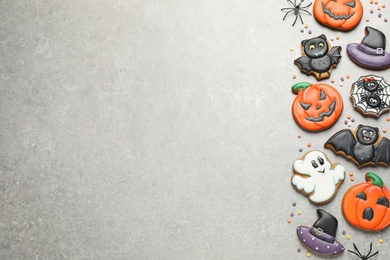 Photo of Tasty Halloween cookies on light grey table, flat lay. Space for text