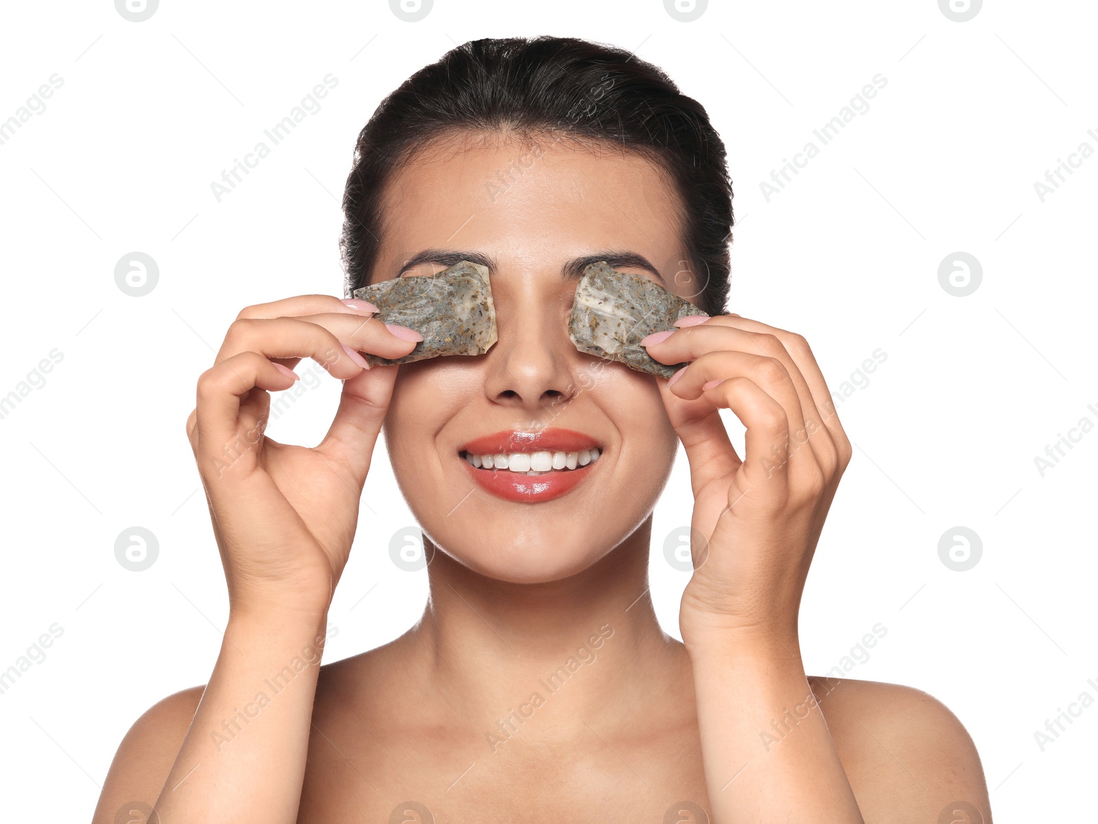 Photo of Woman covering eyes with tea bags on white background. Skin care