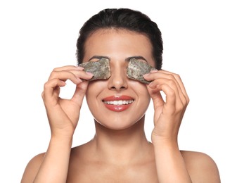 Woman covering eyes with tea bags on white background. Skin care