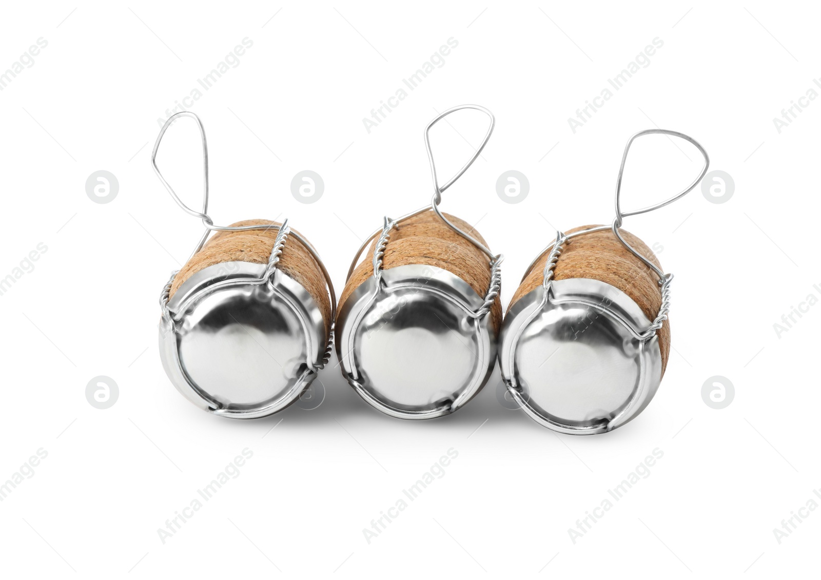 Photo of Sparkling wine corks with muselet caps on white background