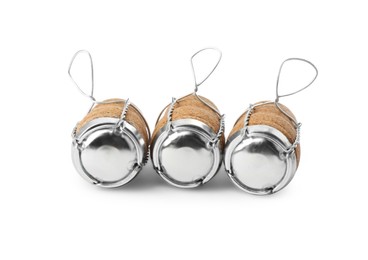 Sparkling wine corks with muselet caps on white background