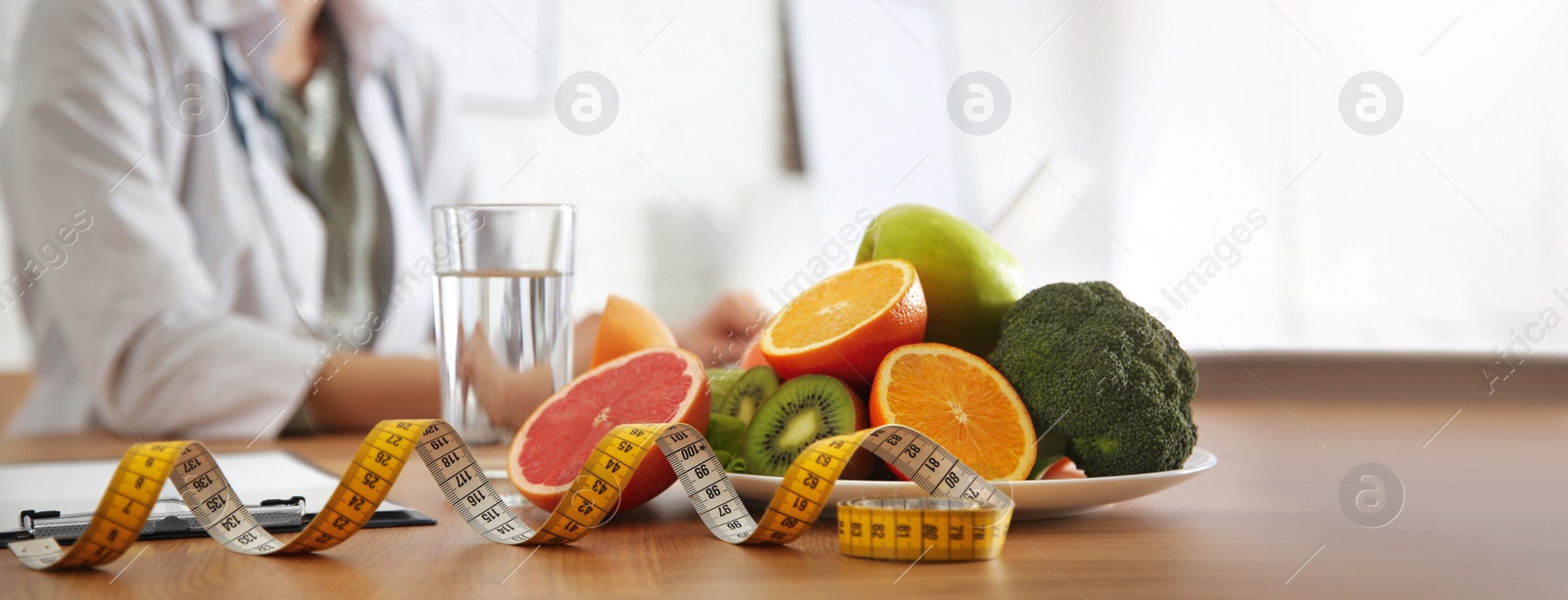 Image of Healthy products, measuring tape and blurred nutritionist on background. Banner design