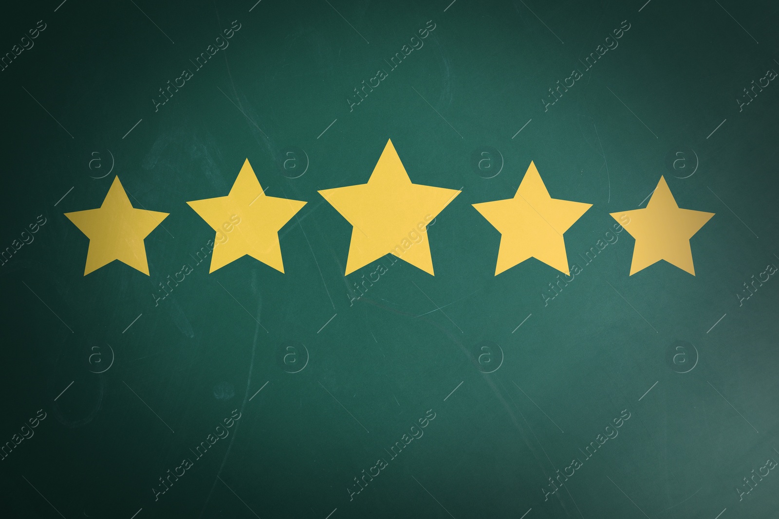 Image of Quality evaluation. Golden stars on green chalkboard