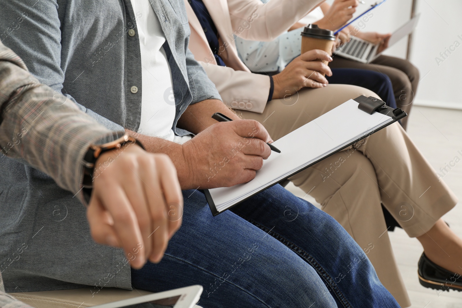 Photo of Man with clipboard waiting for job interview in office, closeup