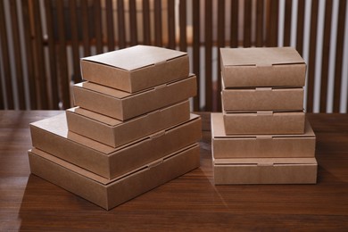 Stacked packaging boxes on wooden table indoors. Production line