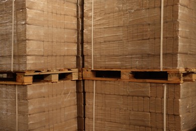 Photo of Stacks of merchandise wrapped in stretch film on wooden pallets