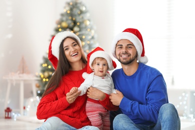 Photo of Happy family with cute baby at home. Christmas celebration