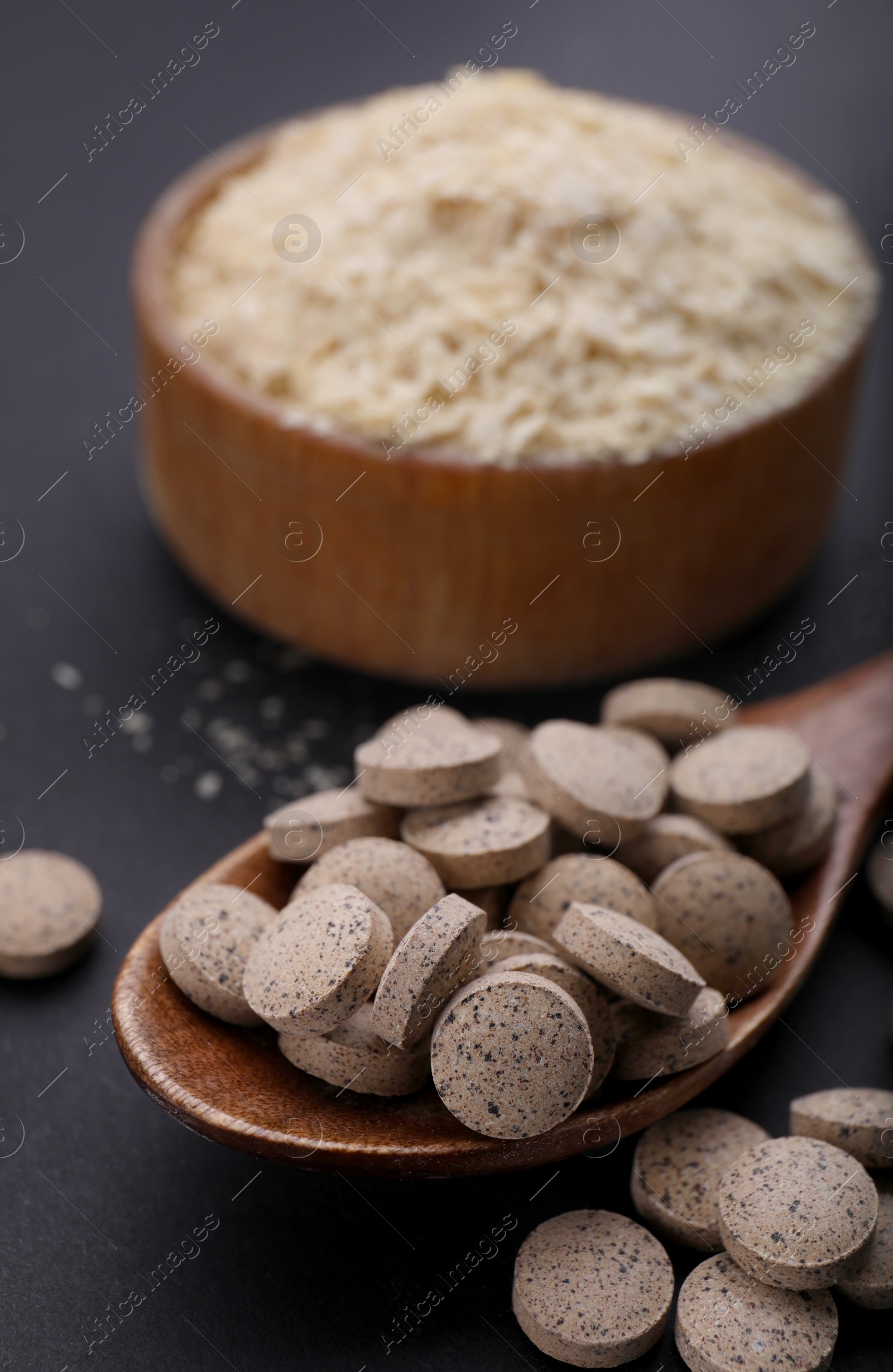 Photo of Different types of brewer`s yeast on black background, closeup