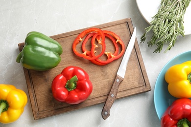 Photo of Wooden board with cut paprika pepper on table, top view