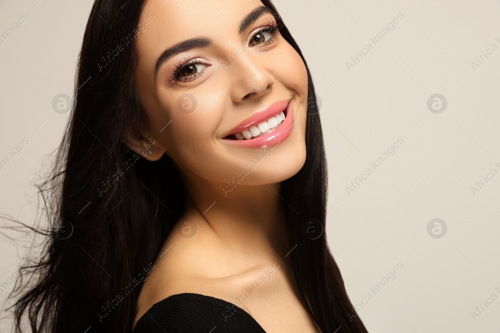 Photo of Portrait of beautiful young woman on light grey background