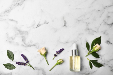 Photo of Flat lay composition with essential oil in bottle, ingredients and space for text on marble background