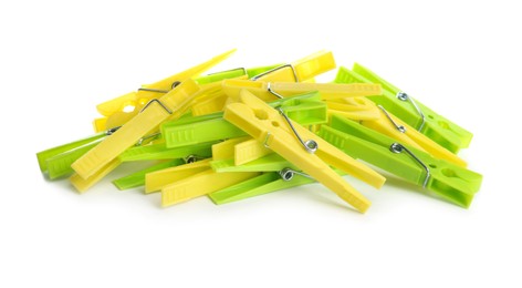 Photo of Many colorful plastic clothespins on white background