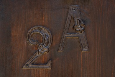 Photo of House number 2A on wooden door, closeup