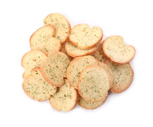 Photo of Heap of crispy rusks with seasoning on white background, top view
